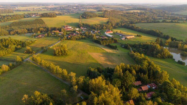 Idyllic aerial view of lush countryside fields and forest in Bohemia.