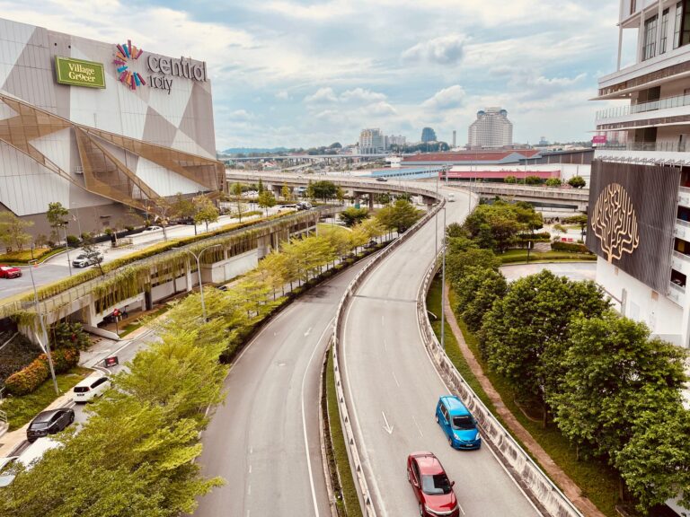 A bustling view of Shah Alam featuring the Central i-City Mall, roads, and greenery.