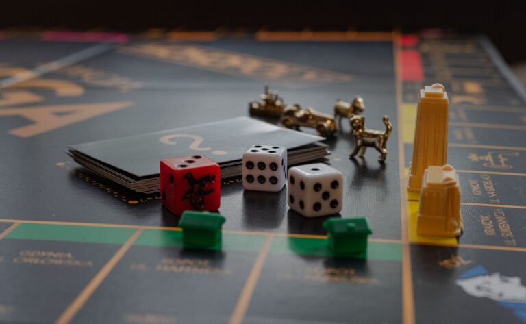 A detailed view of a board game with dice, tokens, and landmarks on a playing board.