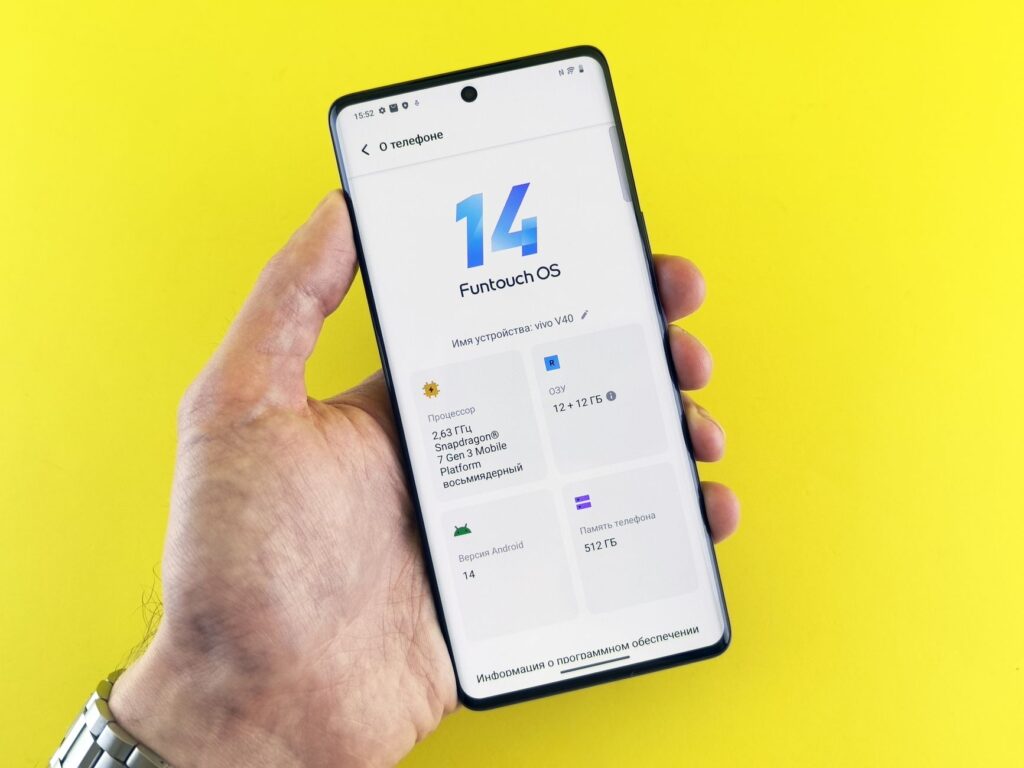 Close-up of a hand holding a smartphone displaying Funtouch OS 14 on a vibrant yellow background.