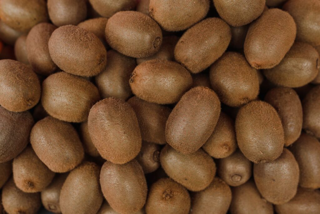A large close-up bunch of ripe kiwis showcasing their fresh texture, perfect for healthy eating.