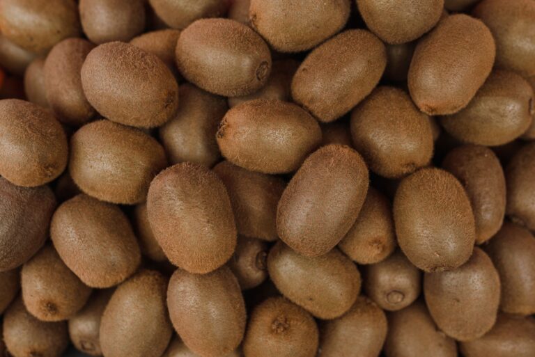 A large close-up bunch of ripe kiwis showcasing their fresh texture, perfect for healthy eating.