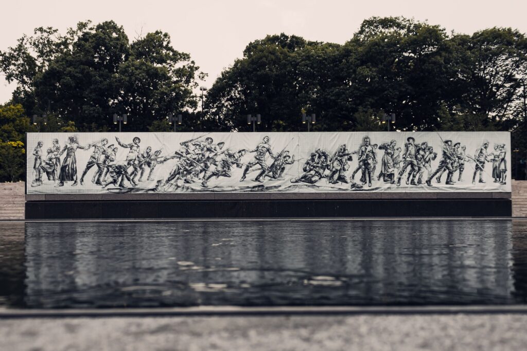 Mural depicting soldiers in action at Pershing Park's World War I Memorial.