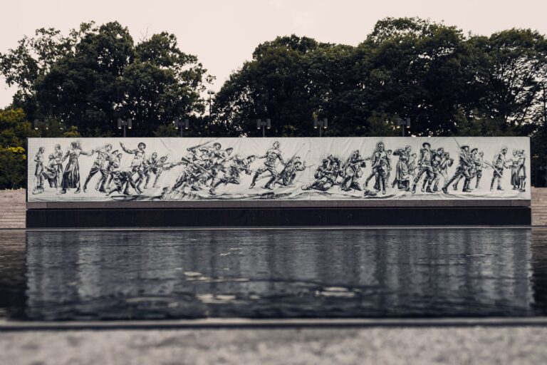 Mural depicting soldiers in action at Pershing Park's World War I Memorial.