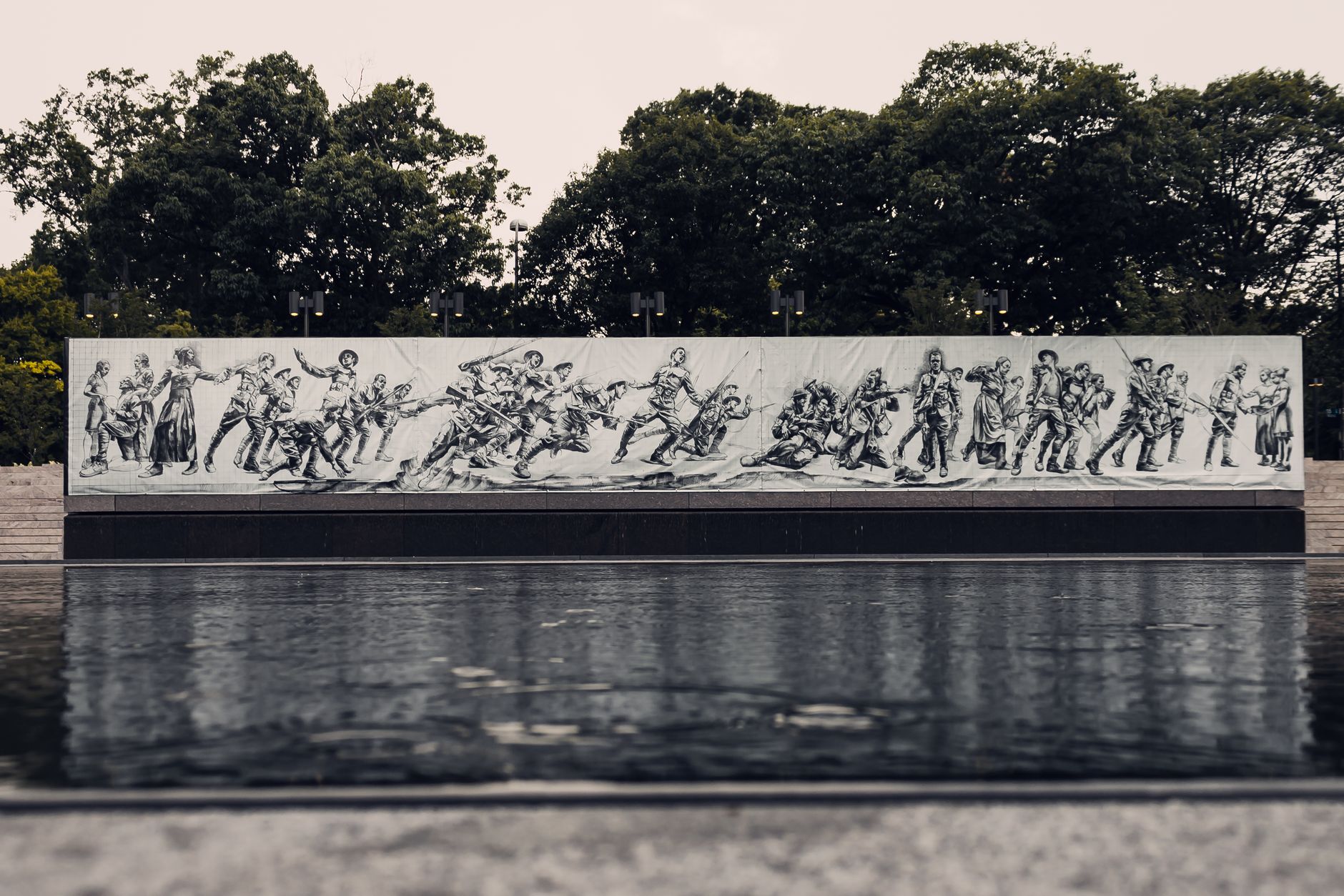 Mural depicting soldiers in action at Pershing Park's World War I Memorial.